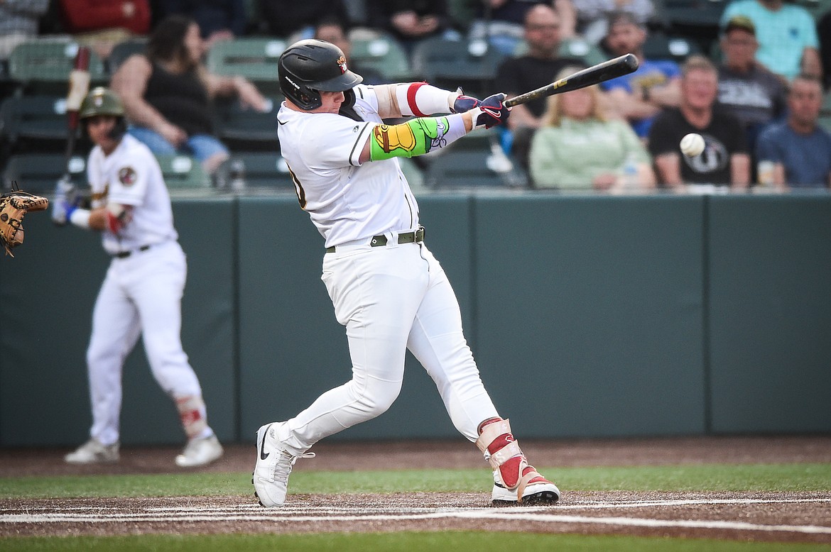 Glacier's Dean Miller (30) connects on a single to right in the fourth inning against the Missoula Paddleheads at Glacier Bank Park on Thursday, Aug. 24. (Casey Kreider/Daily Inter Lake)