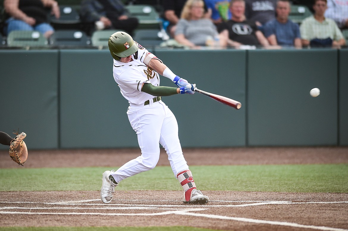 Glacier's Christian Kirtley (12) connects on a double down the line in the second inning against the Missoula Paddleheads at Glacier Bank Park on Thursday, Aug. 24. (Casey Kreider/Daily Inter Lake)