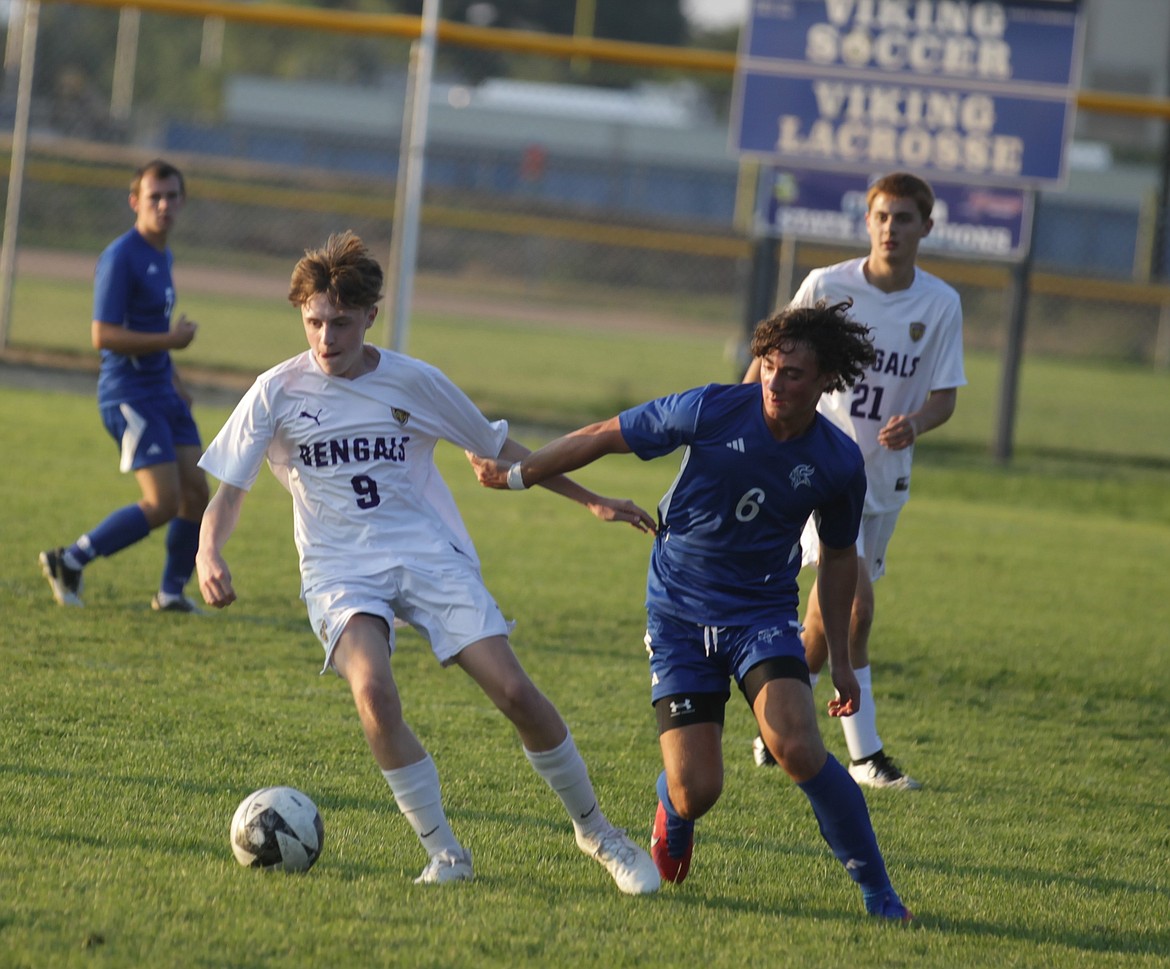 JASON ELLIOTT/Press
Lewiston sophomore midfielder John Millard and Coeur d'Alene junior forward Kason Pintler battle for possession during the first half of Thursday's match at Coeur d'Alene High.