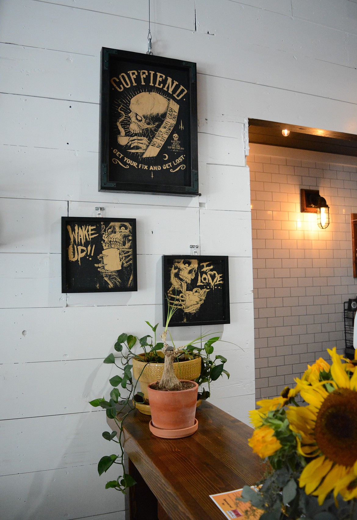 Images that incorporate coffee and skulls adorn the walls at the Tin Snug.