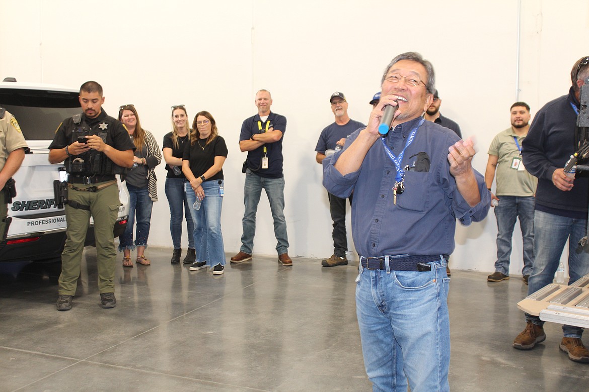 Moses Lake Industries president Hiroyuki Edo speaks to company employees and sheriff's deputies during a donation presentation to the Grant County Sheriff’s Office K-9 unit.