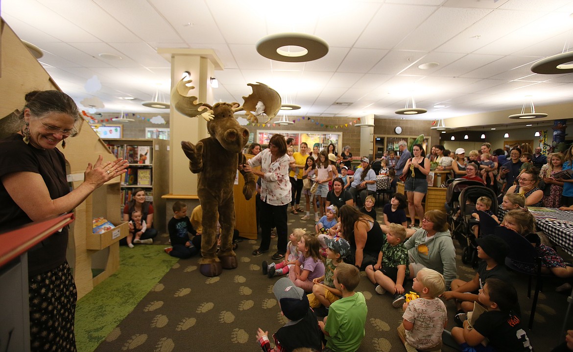 The crowd goes wild as Mudgy Moose makes an appearance Thursday to cut the ribbon on the new story cabin in the children's library at the Coeur d'Alene Public Library.