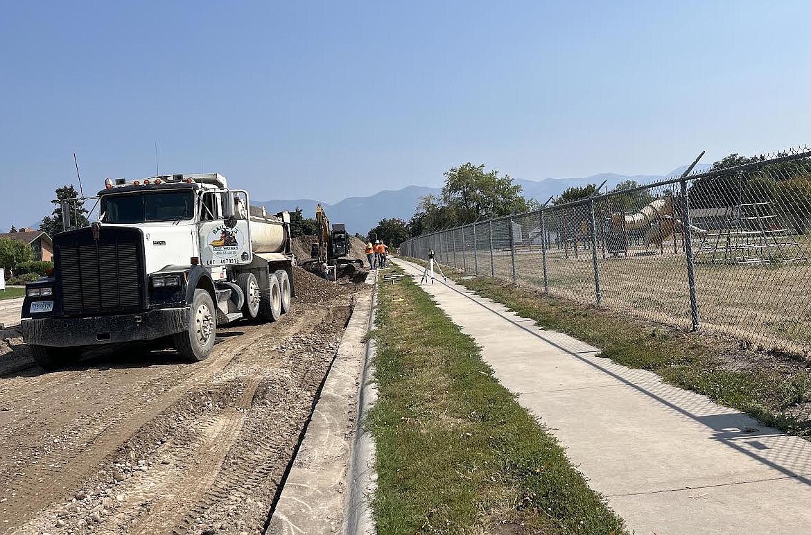Workers hasten to complete construction on 4th Ave. E in Polson before school starts on Tuesday. (Kristi Niemeyer/Leader)