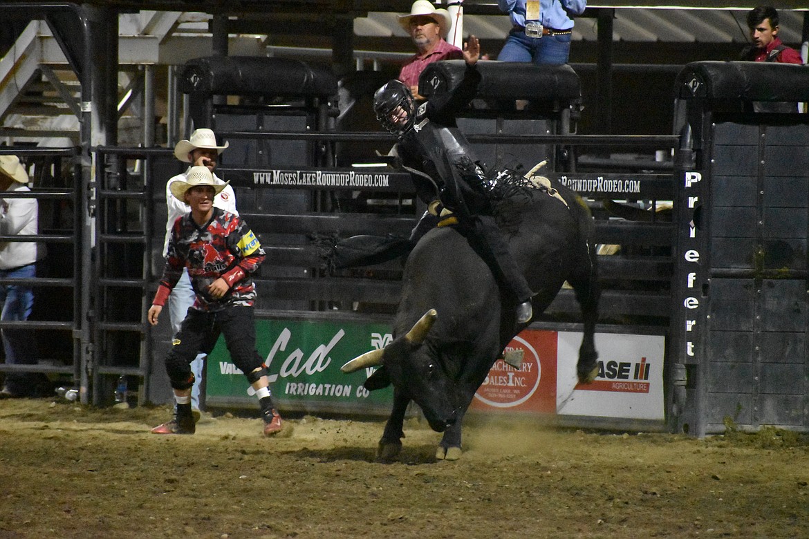 Bull rider Austin Covington keeps his balance on top of the bull Shaved Ice on Thursday’s Moses Lake Roundup.