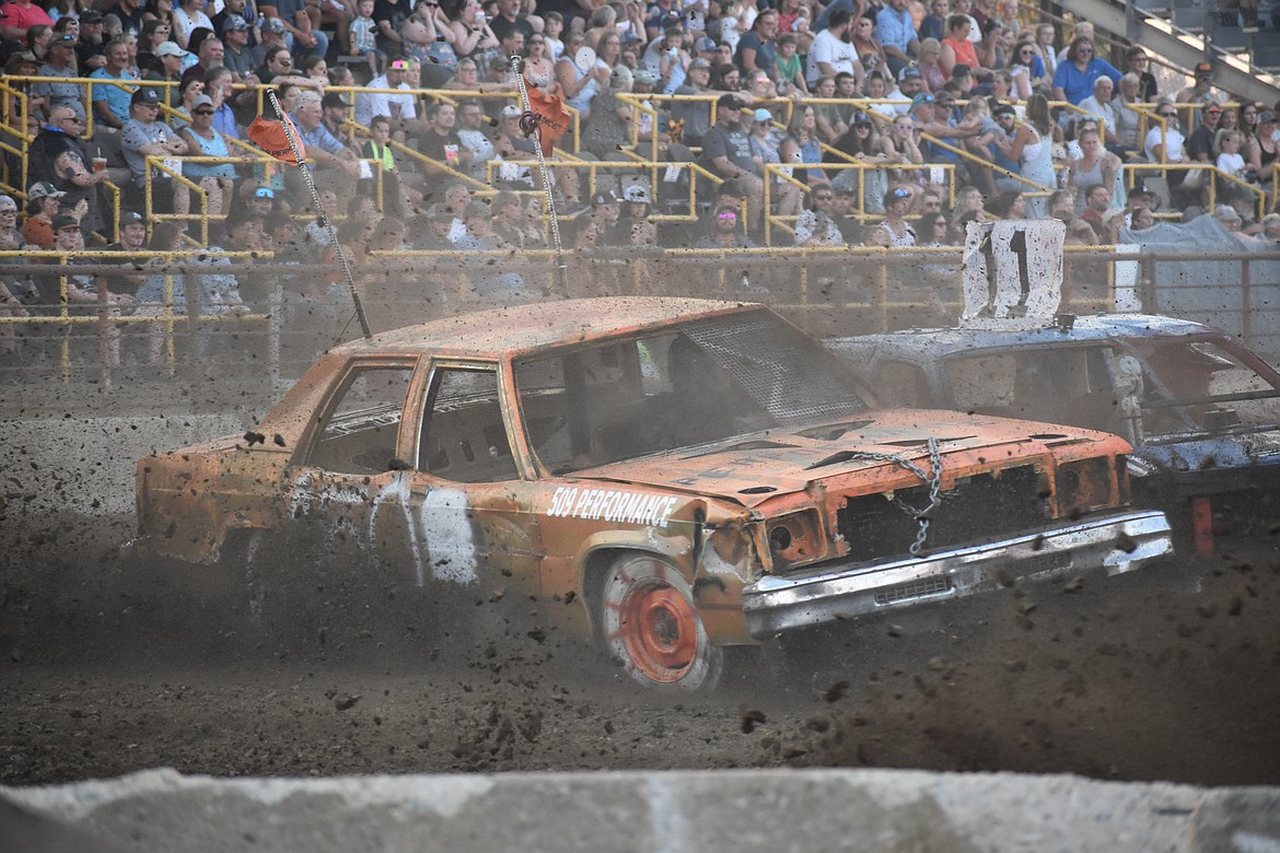 The fast-moving wheels kicked up dirt while making sharp turns at the Agri-Service Demolition Derby on Aug. 16.