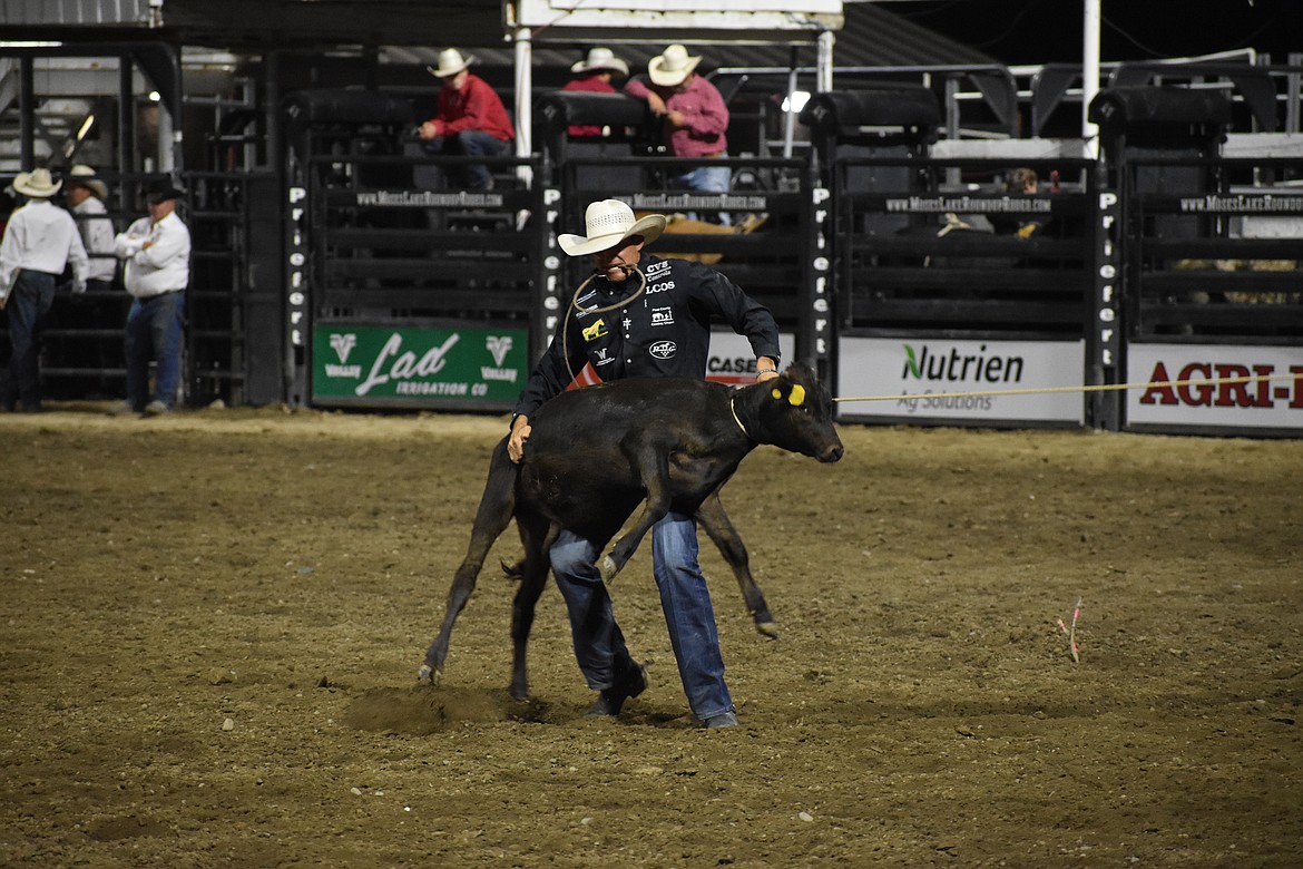 Tie-down roper Kyle Lucas picks up a steer on Thursday at the Moses Lake Roundup.