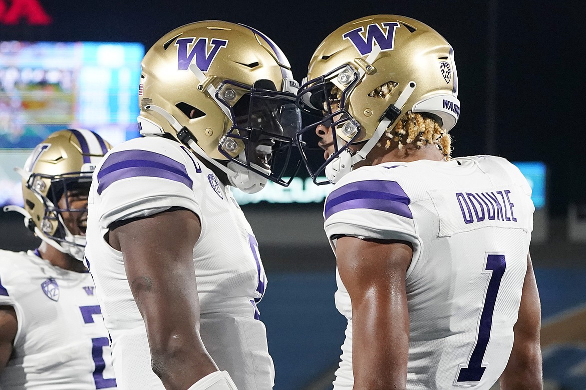 UW quarterback Michael Penix Jr., left, and receiver Rome Odunze, right, were two of 10 Huskies to be named to the Reese’s Senior Bowl watch list on Wednesday.