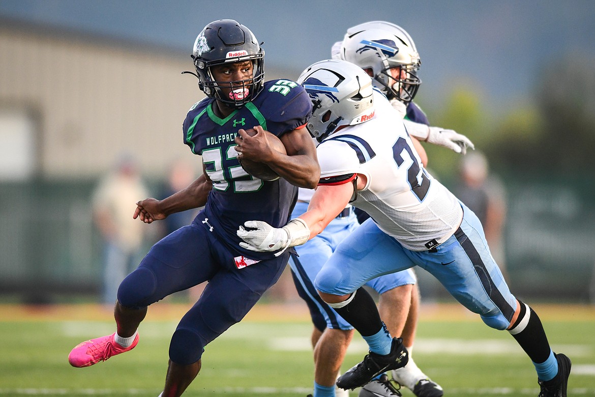 Glacier running back Kobe Dorcheus (33) picks up yardage after a reception in the first half against Great Falls at Legends Stadium on Friday, Aug. 25. (Casey Kreider/Daily Inter Lake)