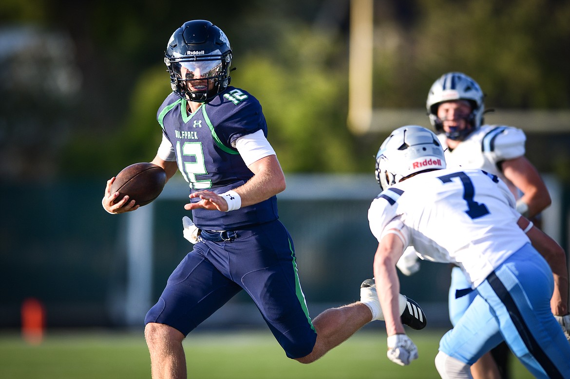 Glacier quarterback Jackson Presley (12) picks up yardage on a run in the first quarter against Great Falls at Legends Stadium on Friday, Aug. 25. (Casey Kreider/Daily Inter Lake)