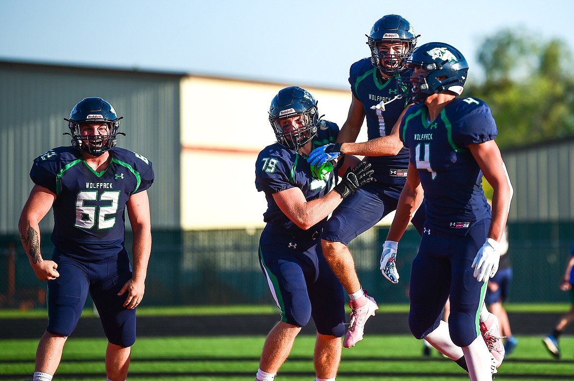 Glacier wide receiver Cohen Kastelitz (1) celebrates with TJ Gannon (62), Aiden Krause (79) and Kole Johnson (4) after a touchdown on a 70-yard flea flicker on the first play of the game against Great Falls at Legends Stadium on Friday, Aug. 25. (Casey Kreider/Daily Inter Lake)