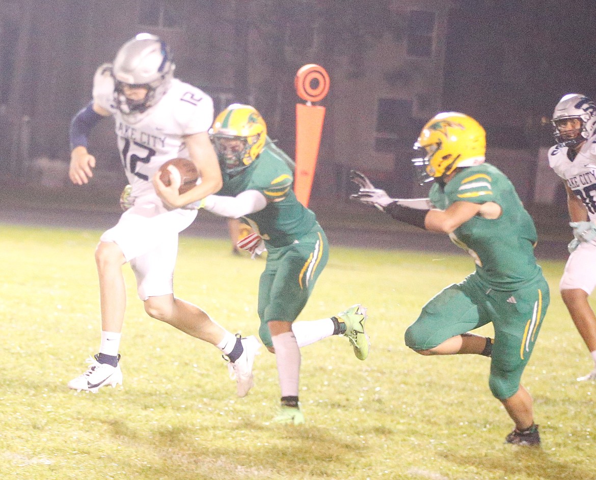 JASON ELLIOTT/Press
Lake City junior quarterback Avrey Cherry breaks through the tackle of Lakeland junior cornerback Ezra Benson during the fourth quarter of Friday's game at Corbit Field in Rathdrum.