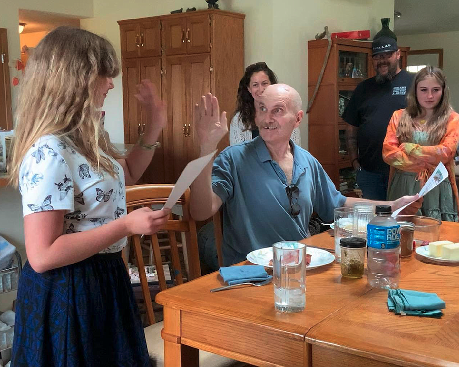 Parkinson's disease patient Dennis Manley of Post Falls high-fives his daughter, Aylis Manley, 11, on Father's Day when it was announced One More Time Northwest would send them on a trip to Snake Discovery in Minnesota. The daddy-daughter duo share a love of reptiles and went on the trip Aug. 11-13.