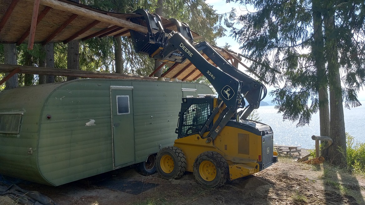 ParaDyce Builders crews volunteered a driver, a skid-steer with a grapple, and a dump-trailer to remove a large wood roof and camper trailer from the Pend d'Oreille Bay Trail.