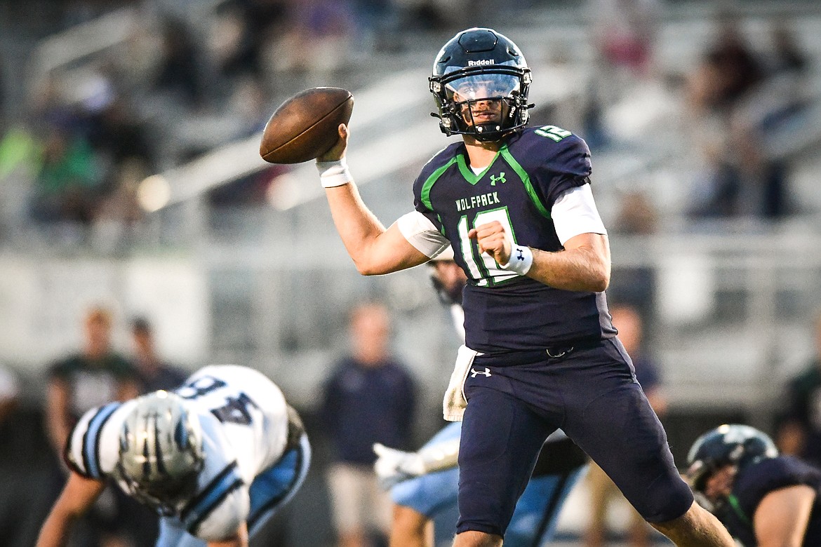Glacier quarterback Jackson Presley (12) looks to pass in the third quarter against Great Falls at Legends Stadium on Friday, Aug. 25. (Casey Kreider/Daily Inter Lake)