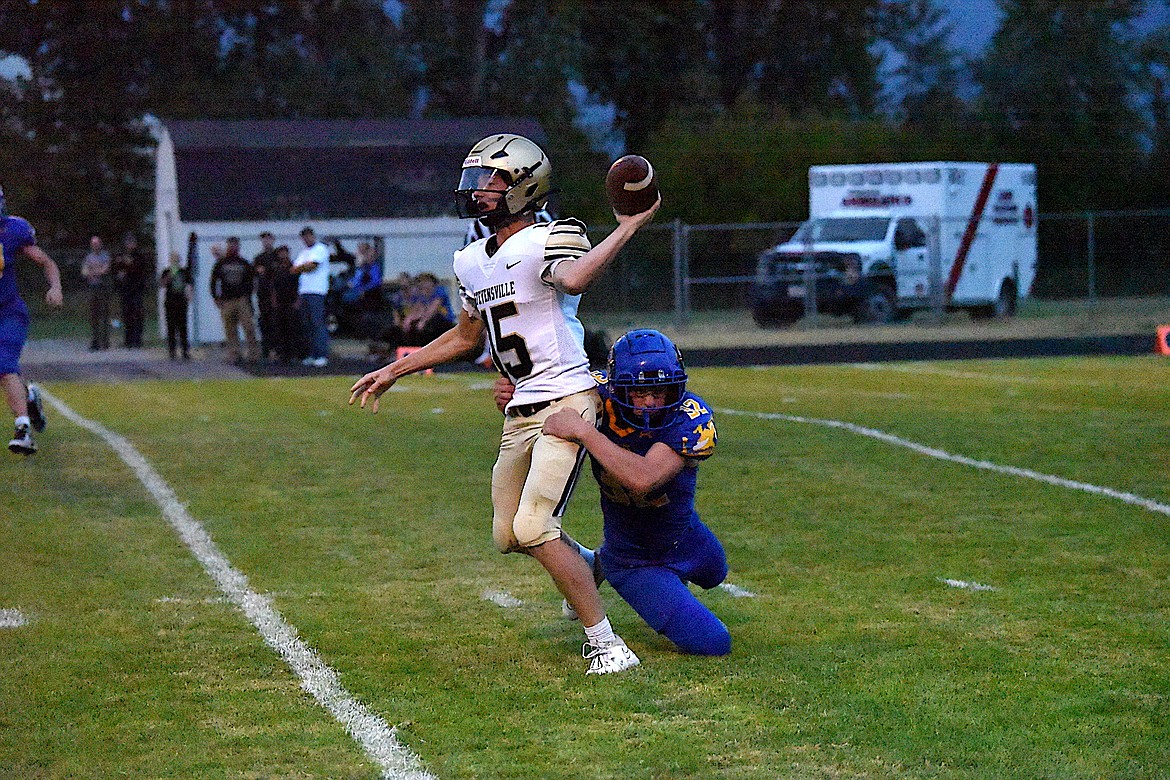 Libby defensive end Joel Goodman puts pressure on Stevensville quarterback Kaeden Gum in the third quarter of Friday's game, leading to an interception by Ryan Beagle. The Loggers turned the interception into a touchdown that gave them a 21-6 lead. (Scott Shindledecker/The Western News)