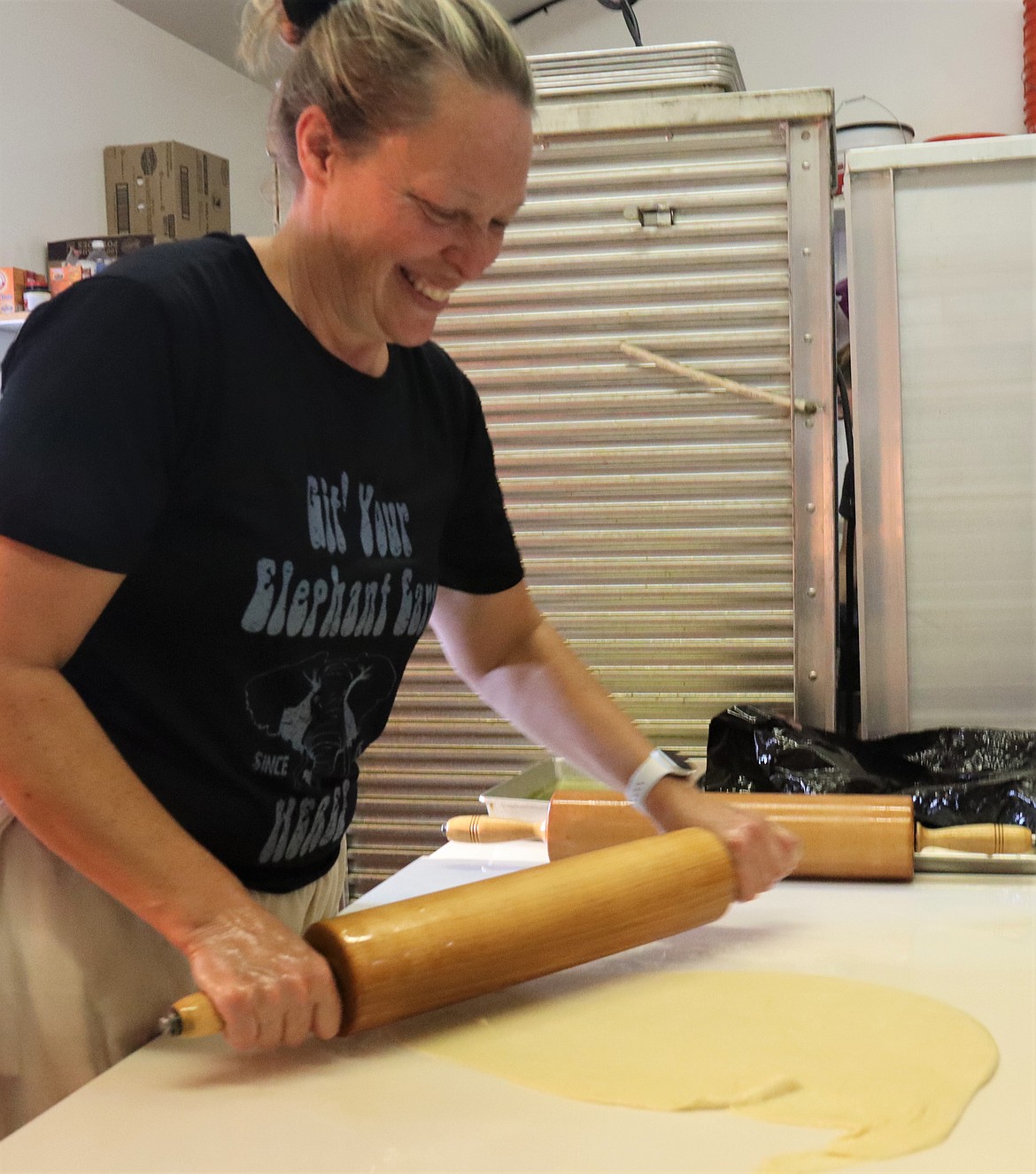 Holly Wallace rolls out the dough to make elephant ears during the North Idaho State Fair on Saturday.