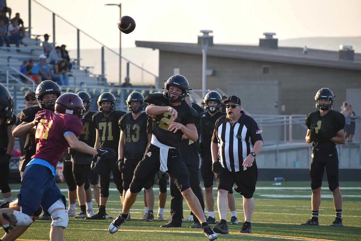 Royal quarterback Lance Allred (2) throws on the run against the Moses Lake defense.