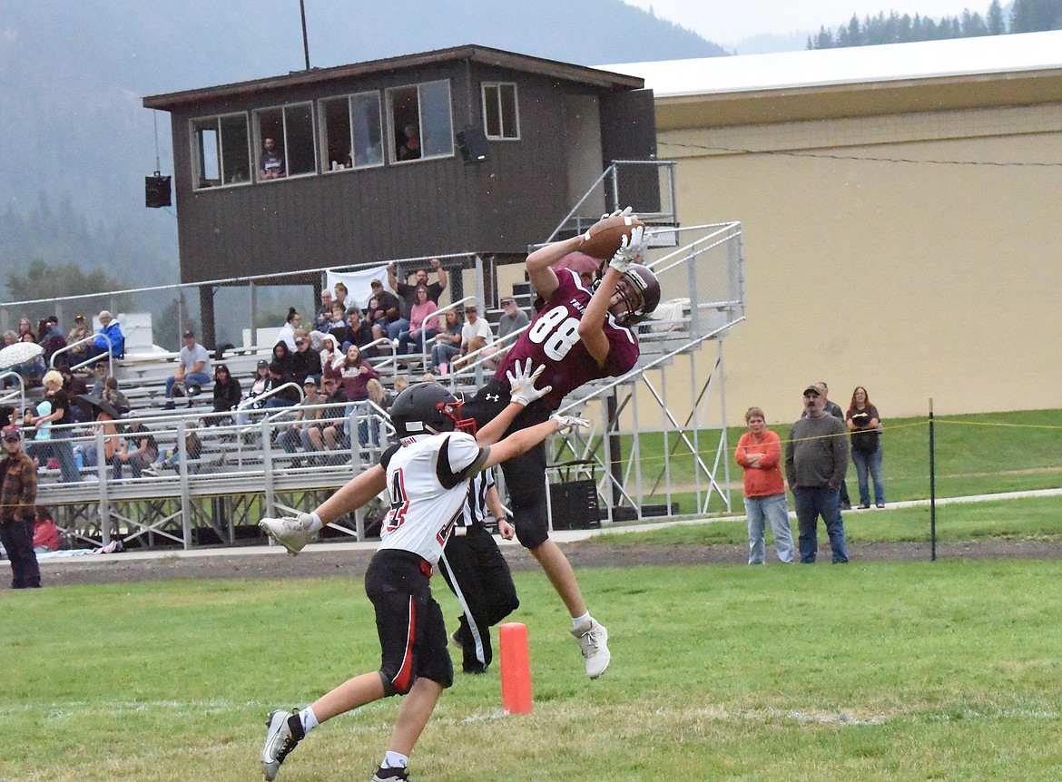 Troy's Kempton Sloan catches a touchdown pass from quarterback Carson Orr in Friday's game against Darby. (Scott Shindledecker/The Western News)