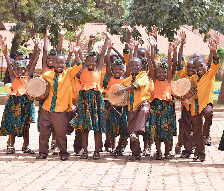 An older choir group composed of African children from ages 10 to 12. The choir is part of nonprofit charity the Music for Life Institute, which raises money to educate and assist children in Africa.