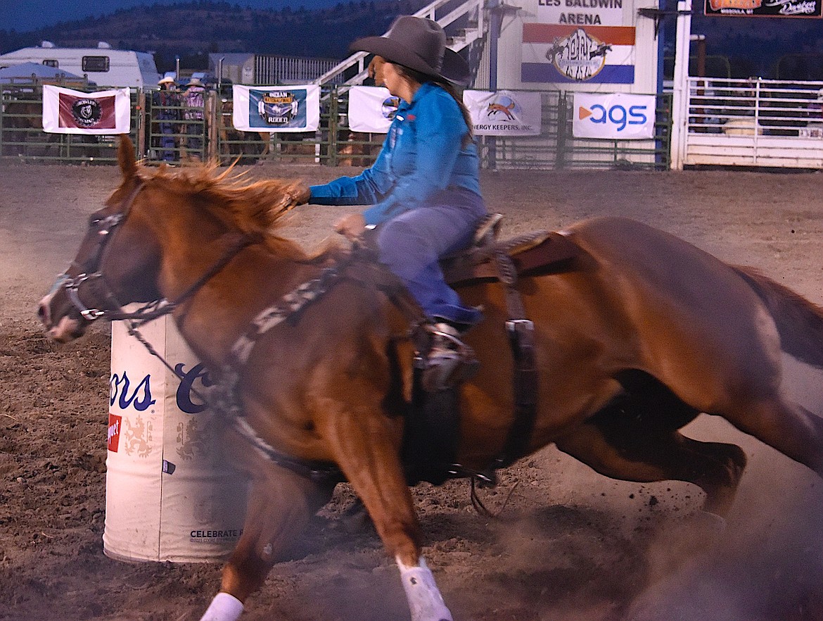 An Indian cowgirl and her big sorrel make the first turn in the barrel racing and look on to the next barrel. (Berl Tiskus/Leader)