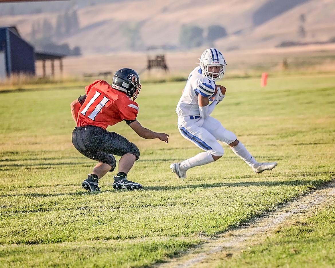 Mission Bulldog Iyezk Umphrey plays keep-away against a Plains player during last Friday's winning contest. (Christa Umphrey photo)