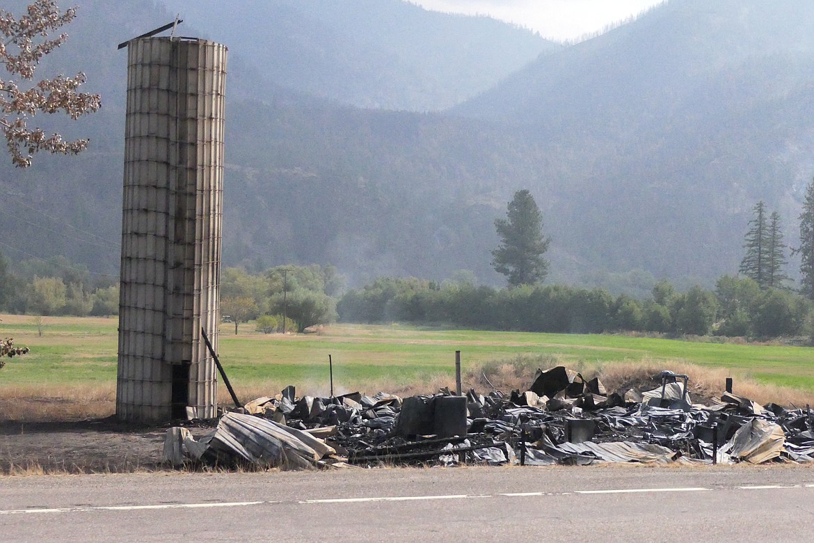 All that remains of a large wooden dairy barn that was lost to the River Road East fire. The barn sits adjacent to Highway 200 two miles south of Paradise. (Chuck Bandel/VP-MI)