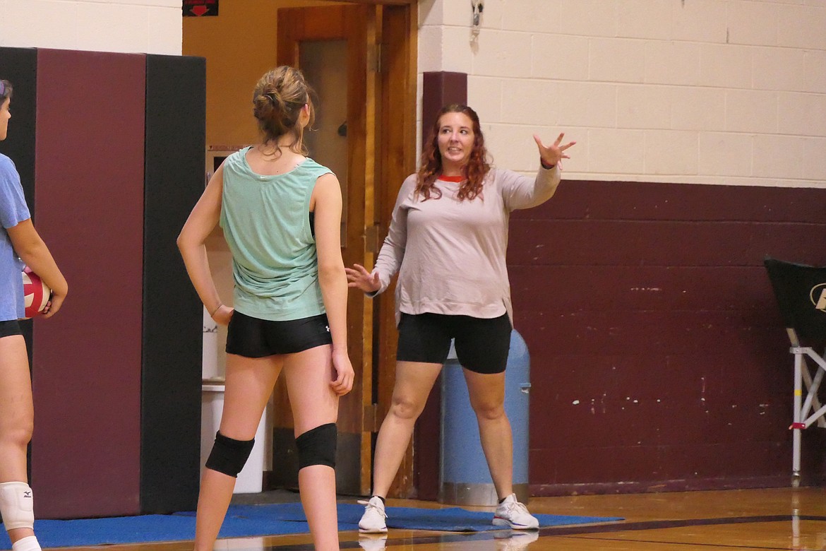 Alberton volleyball coach Dana Smith (grey shirt) works with members of this year's team on improving all aspects of their game. (Chuck Bandel/MI-VP)