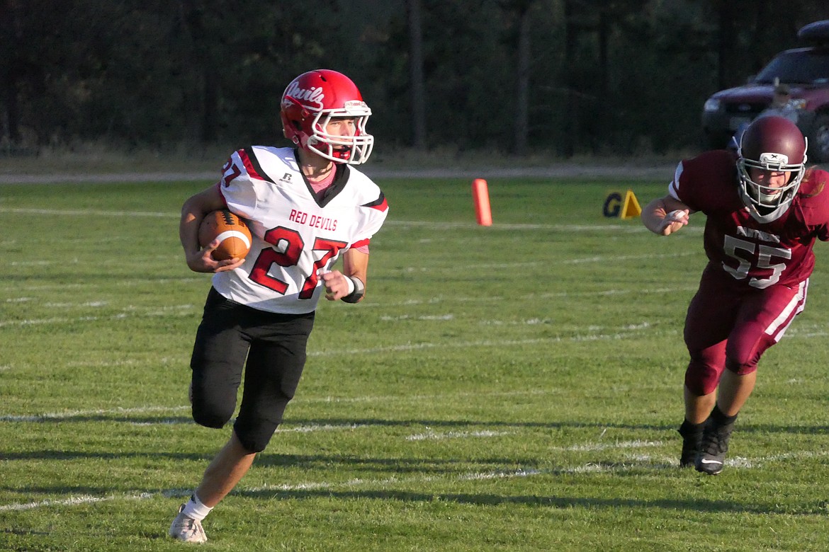 Noxon running back Antonio Lodi sweeps outside on his way to a first half touchdown in the Red Devils road win over Alberton Friday evening.  (Chuck Bandel/MI-VP)