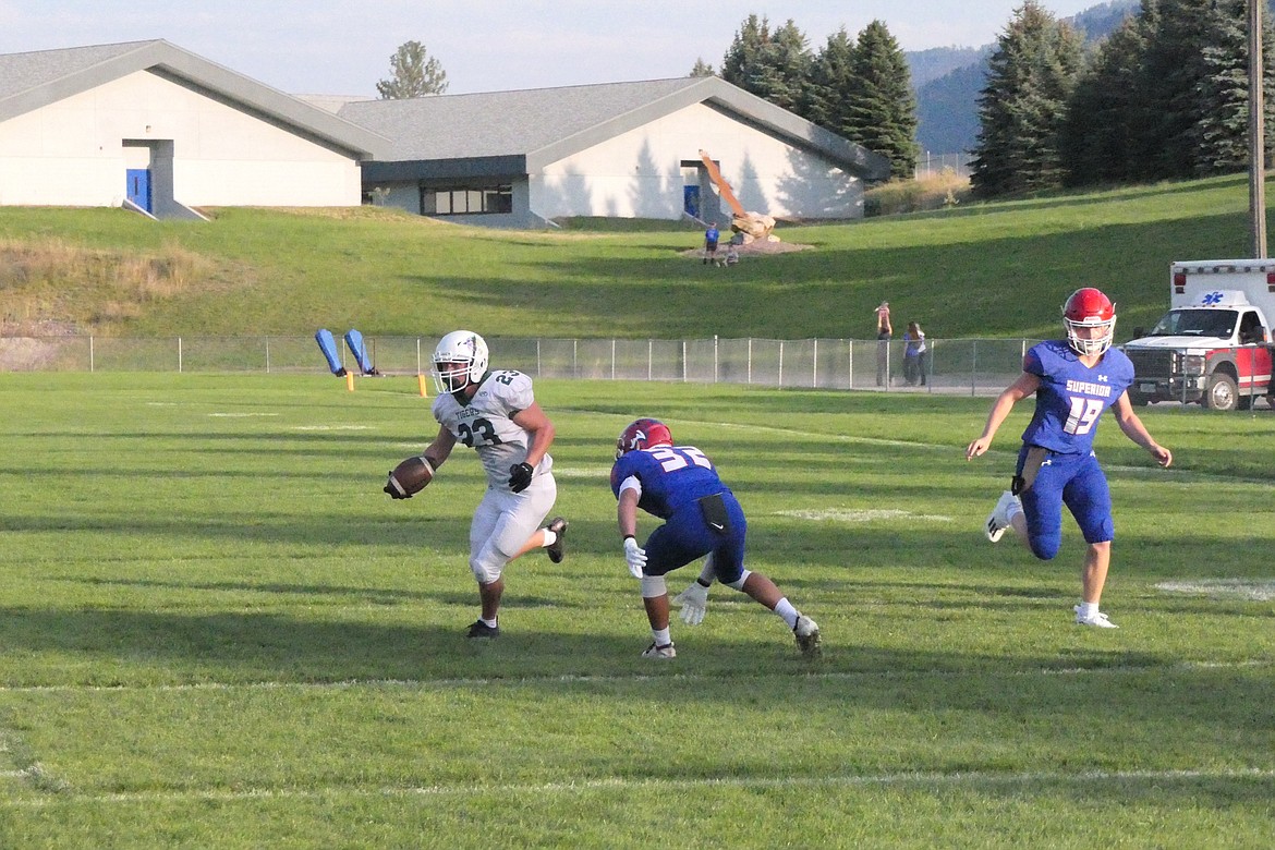 St. Regis senior running back John Pruitt evades a tackle attempt by Superior senior Lucas Kovalsky during first quarter action of their game Saturday night in Superior. (Chuck Bandel/MI-VP)