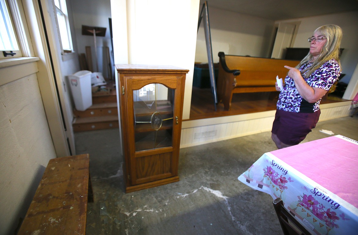 Kathy Darrar, Pleasantview Community Association president, gestures Monday to a cabinet that was smashed when someone broke into the old Pleasantview School in Post Falls earlier this summer. The damage, which includes several small fire attempts, the discharge of a fire extinguisher and more, was discovered Aug. 16.