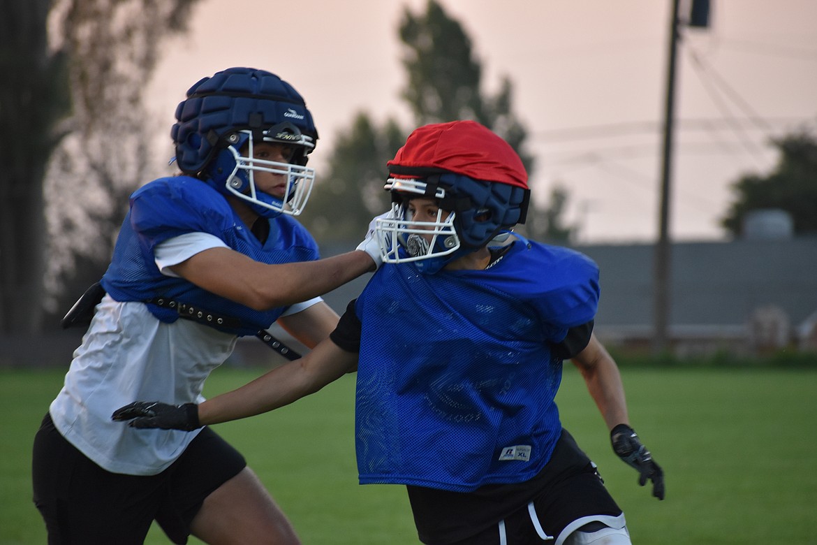 A Warden defender gets past a blocker during practice on Aug. 24.