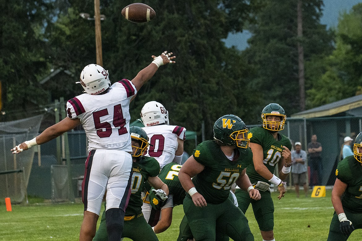 Bronc Trevor Lewis jumps to interfere with Bulldog quarterback Mason Kelch’s pass in Whitefish’s first game of the season against Hamilton at the Dog Pound on Friday, Aug. 25. (Avery Howe/Hungry Horse News)