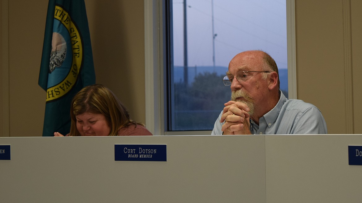 Soap Lake School Board member Curt Dotson, right, participates in the discussion on the Collective Bargaining Agreement between the Soap Lake Coaches Association and the Soap Lake School District, which was approved at Monday’s meeting.