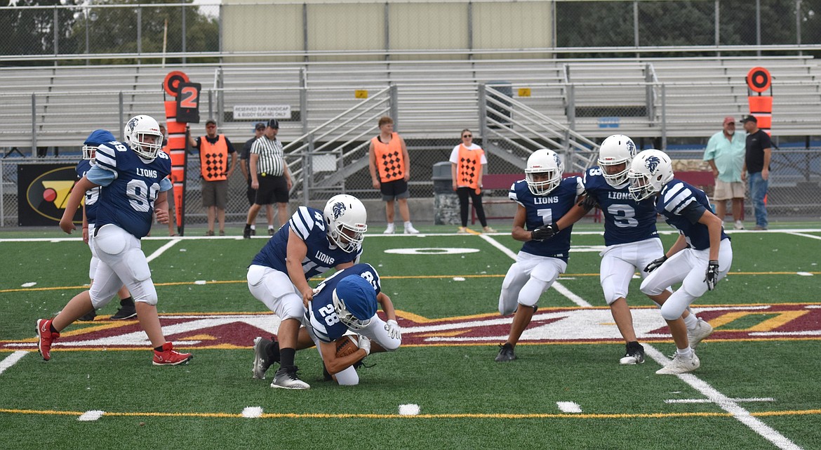 Moses Lake Christian Academy/Covenant Christian School Lions lineman Andrew Kibukevich brings down running back/defensive back Eddy Dovmat at a practice scrimmage Saturday at Lions Field in Moses Lake.