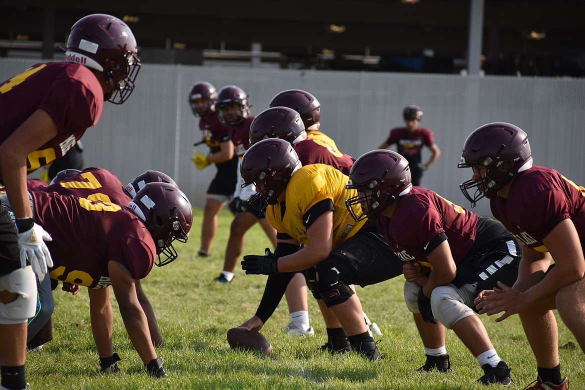 The Moses Lake offensive line lines up against the Maverick defense during practice on Aug. 23.