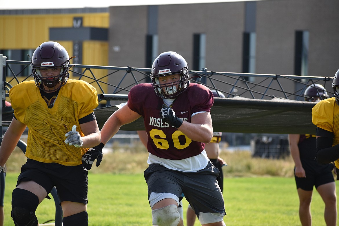 Moses Lake junior Brayden Kast (60) runs upfield during a drill at an Aug. 23 practice.