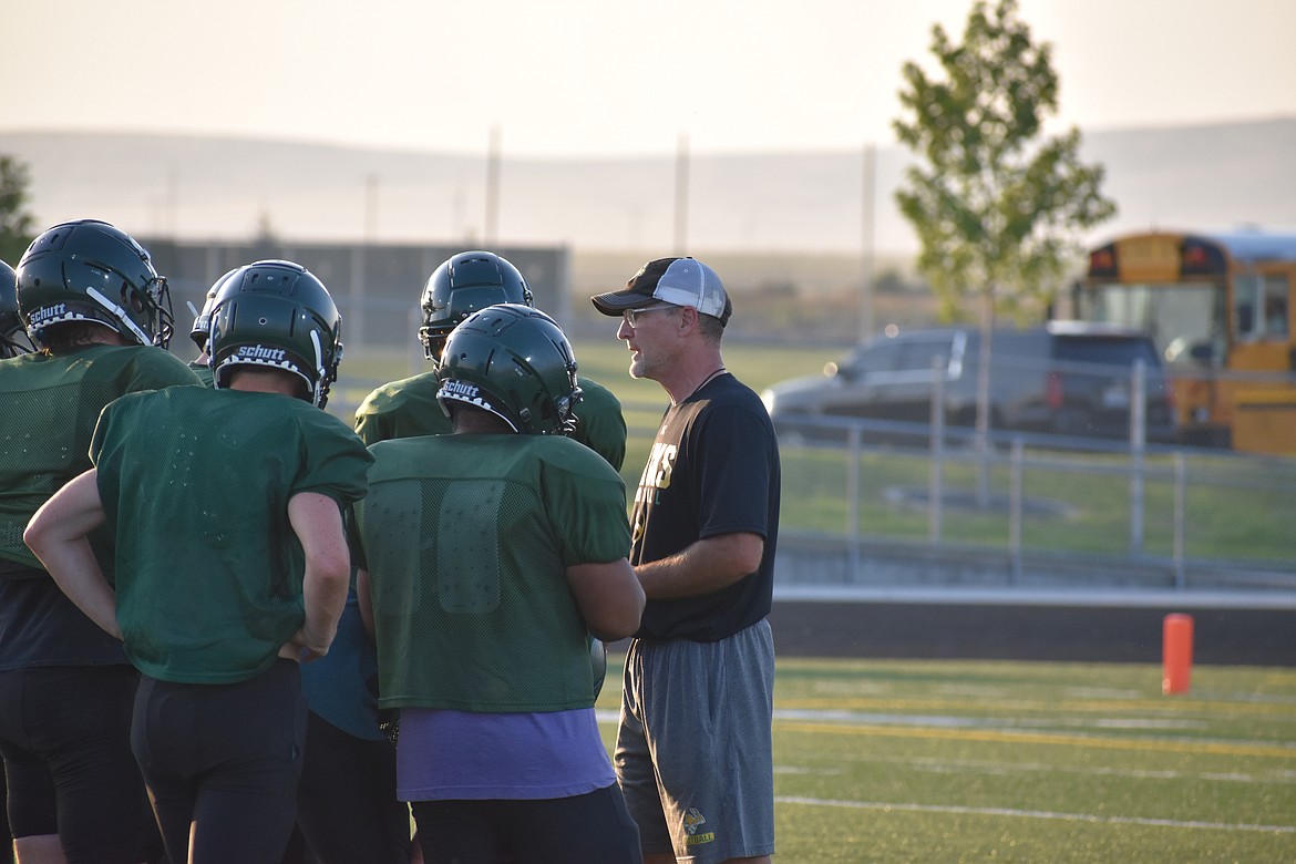 Quincy Coach Russ Elliott talks to his team during the team’s preseason jamboree Aug. 25.