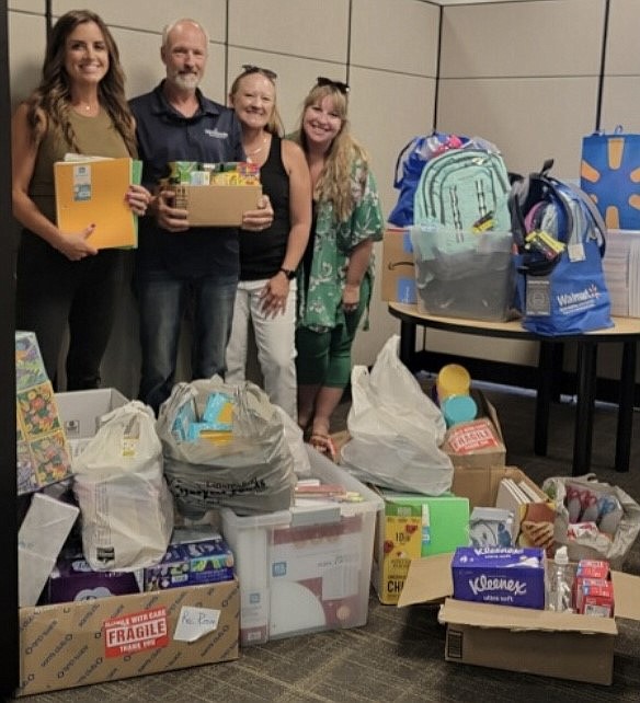 From left: Tami Canfield, Kevin Burgess, Annie Fisher and Danielle Root with some of the supplies collected for the school supply drive by the Moses Lake-Othello Association of Realtors.