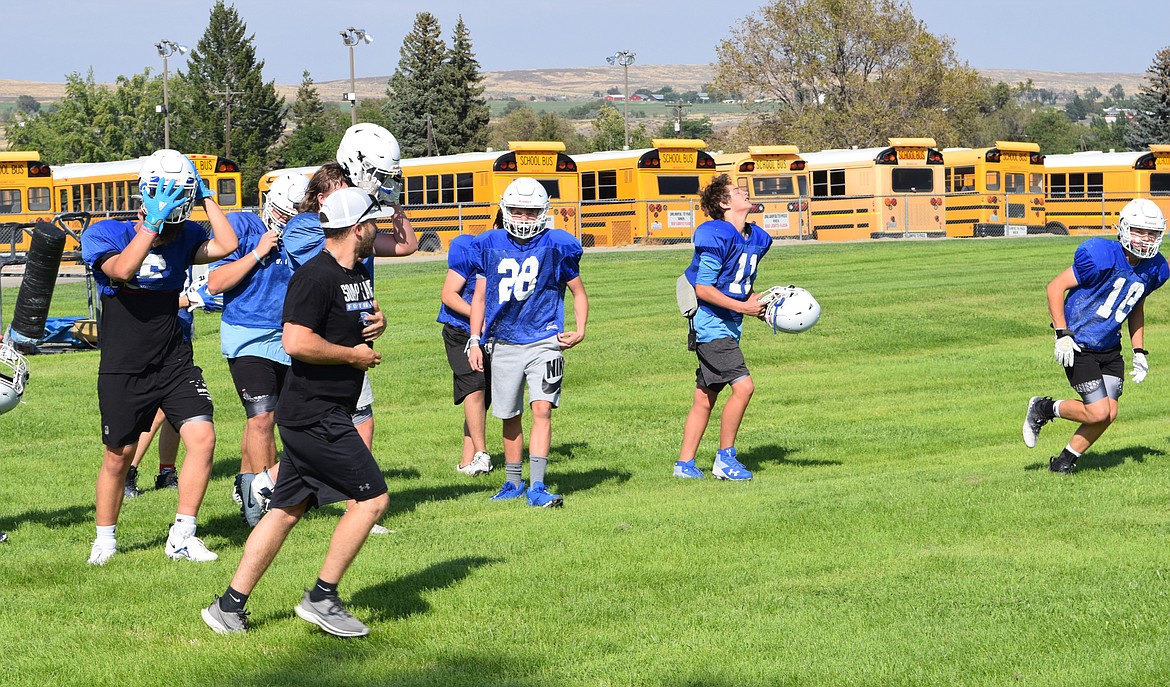 Head Coach for the Soap Lake football team Garrett Devine leads players onto the field for an Aug. 22 outdoor afternoon practice.