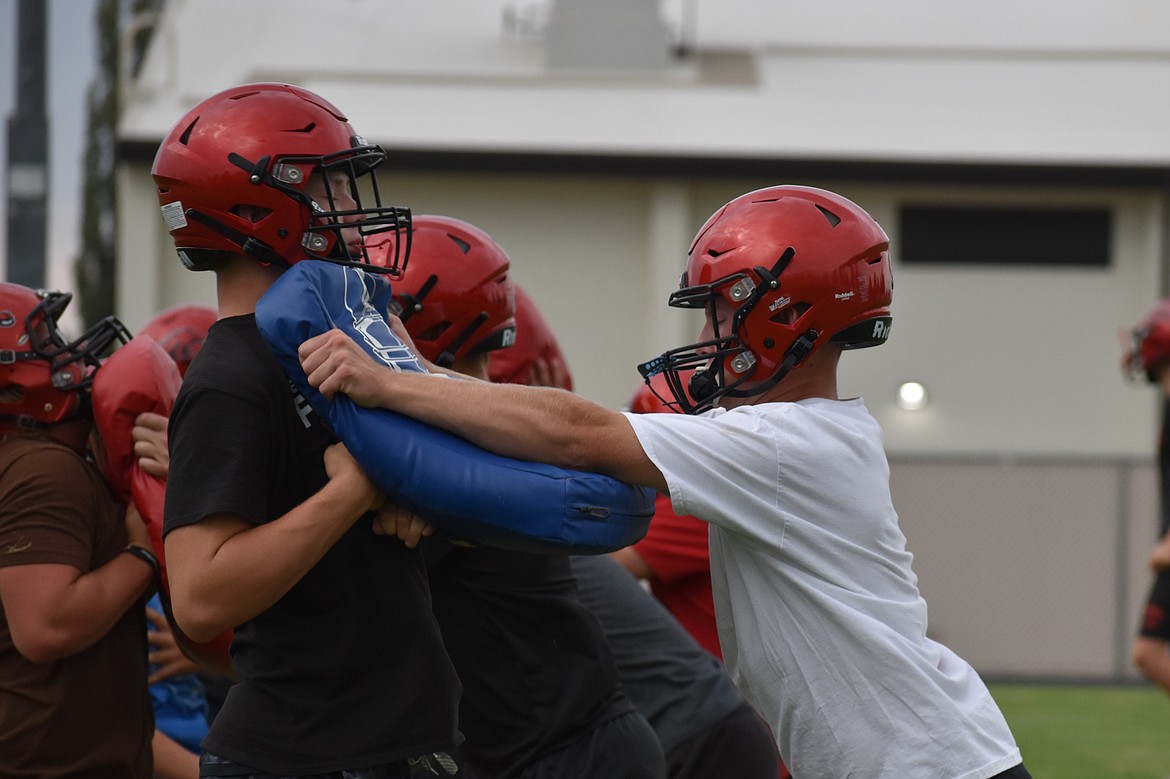 Lineman work with body shields during a Bronco practice on Aug. 17.