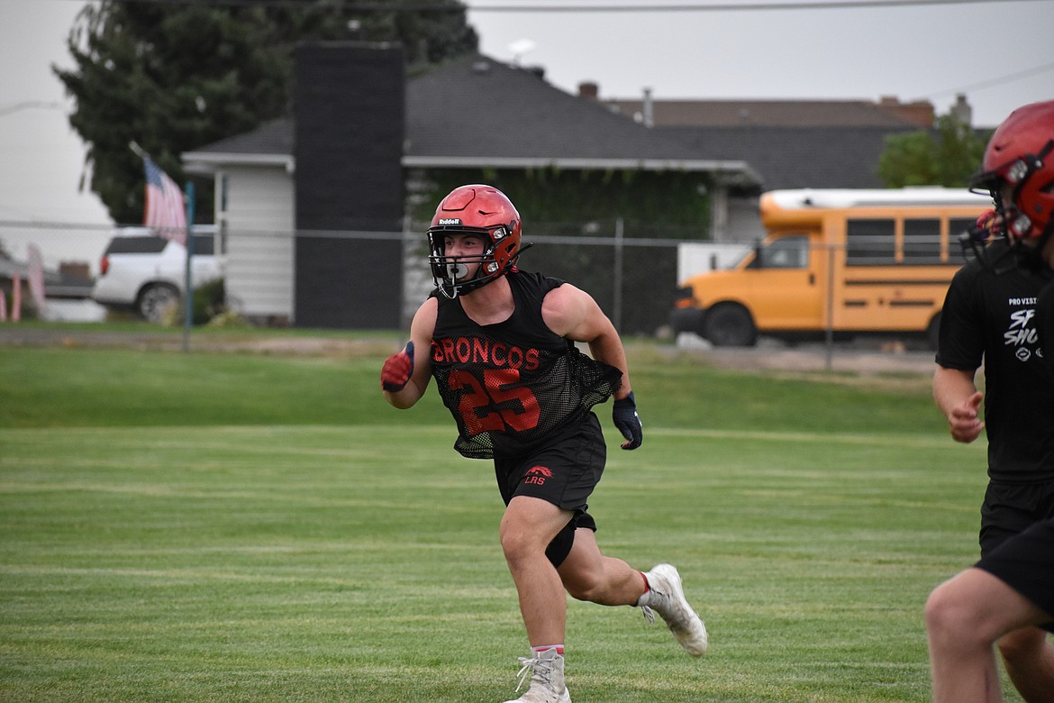 Junior running back/linebacker Brody Boness rushes forward during a drill in practice.