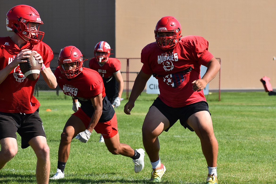 Othello defensive lineman Mason Perez, right, looks toward the quarterback during a pursuit drill.