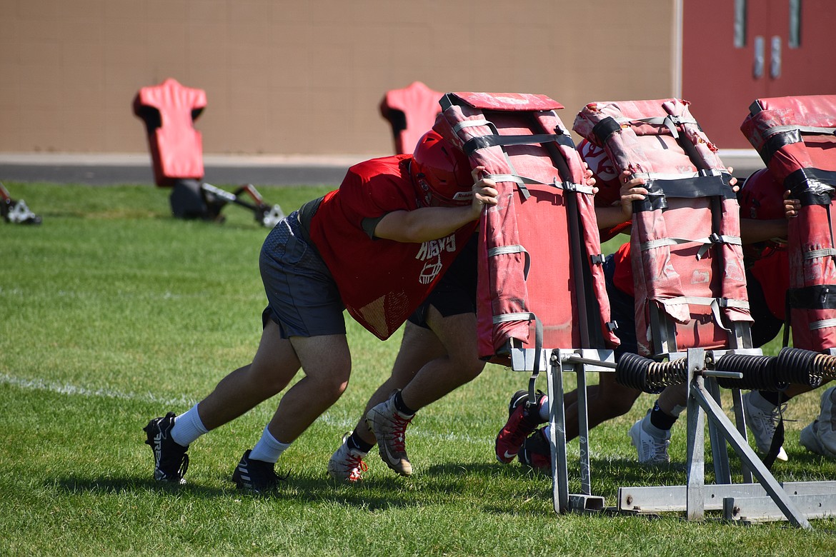 Othello players push a blocking sled during practice on Aug. 25.