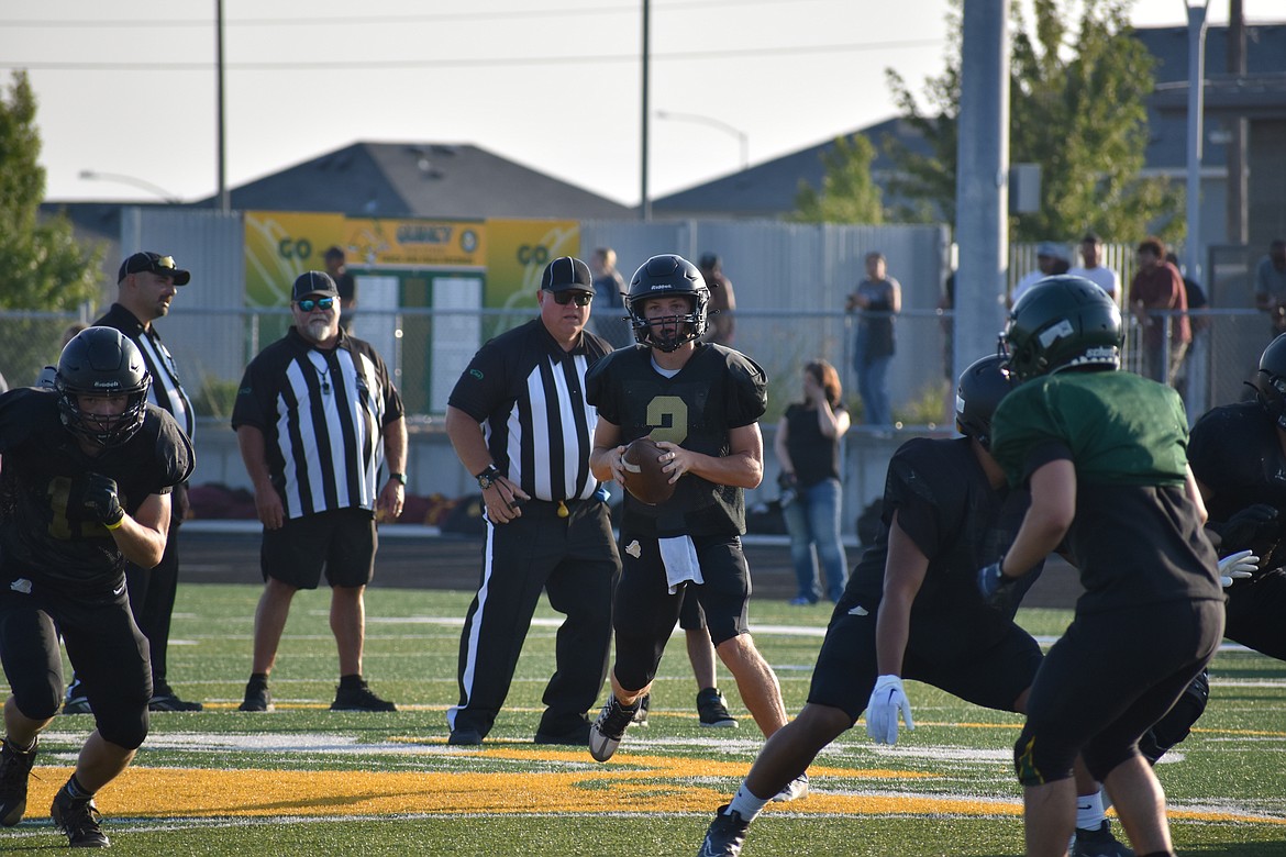 Royal junior Lance Allred drops back to pass at a jamboree in Quincy on Friday. Allred is taking over the quarterback position, replacing his brother Dylan who graduated last year.