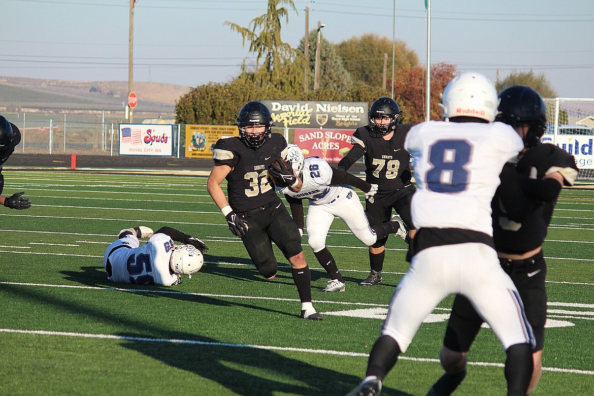 Senior running back Kaleb Hernandez (32) evades defenders. The 2022 playoffs began at home for Royal, who opened with a 41-7 win over Cascade Christian.