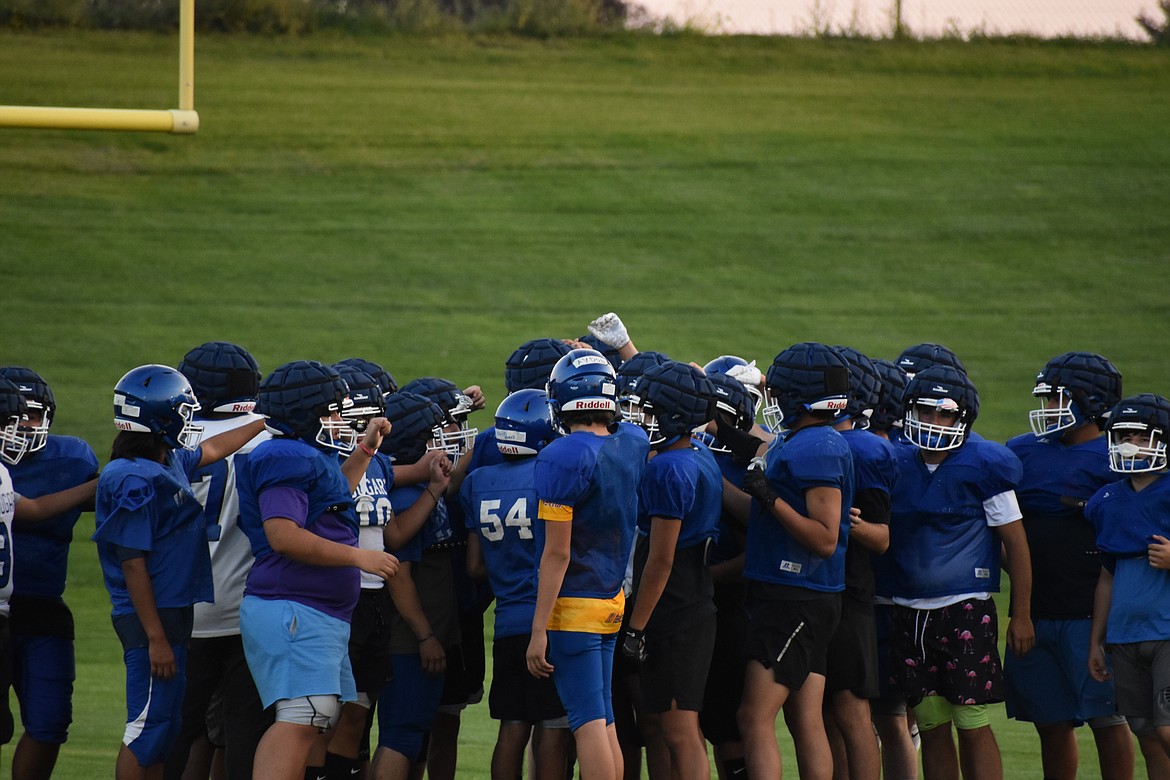 The Warden Cougars break down a team huddle after the beginning of practice.