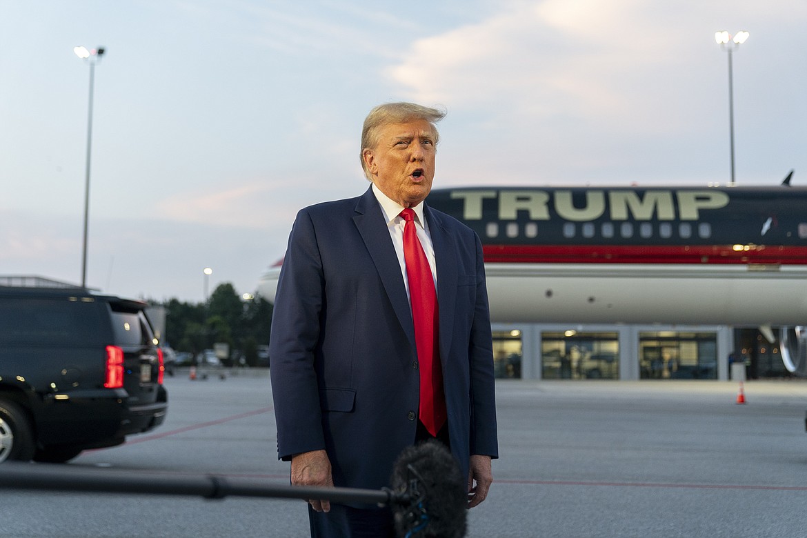 Former President Donald Trump speaks with reporters before departure from Hartsfield-Jackson Atlanta International Airport, Thursday, Aug. 24, 2023, in Atlanta. Trump has pleaded not guilty and waived arraignment in the case accusing him and others of illegally trying to overturn the results of the 2020 election in Georgia. (AP Photo/Alex Brandon, File)