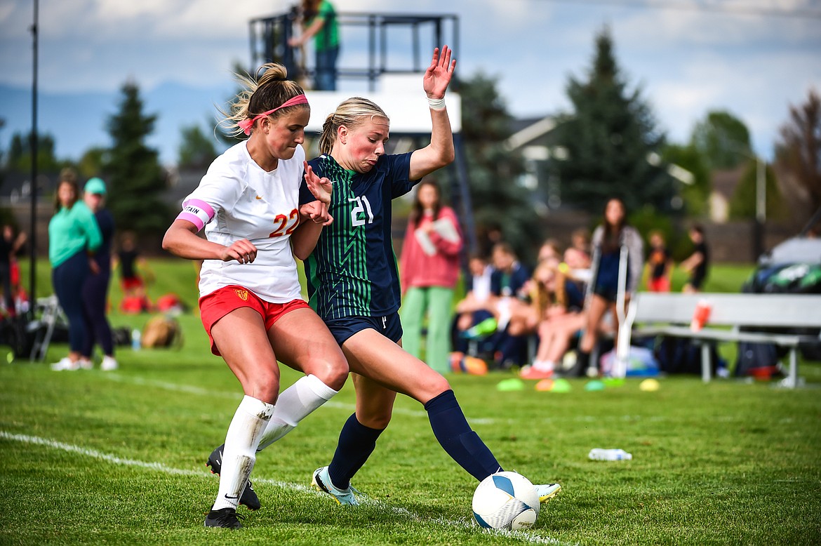 Glacier's Emmery Schmidt (21) battles for possession with Missoula Hellgate's Chloe Larsen (22) in the second half at Glacier High School on Thursday, Aug. 31. (Casey Kreider/Daily Inter Lake)