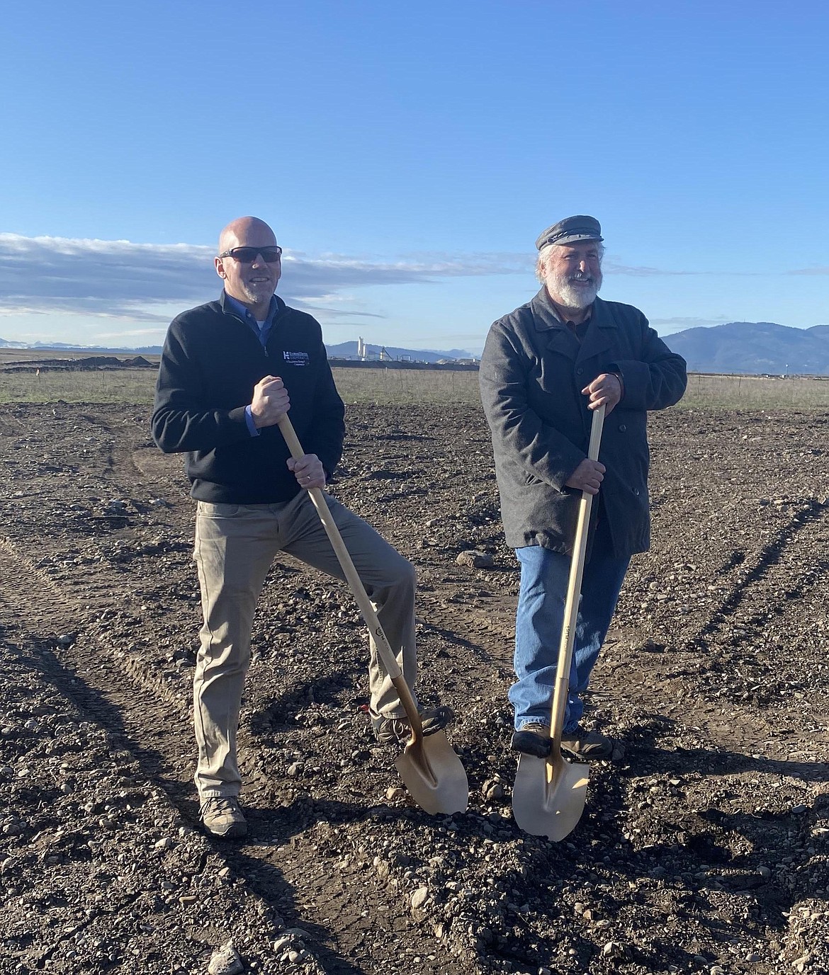 Kootenai Electric Cooperative CEO Doug Elliott, left, breaks ground with Rathdrum Mayor Vic Holmes in 2022 at the site of Kootenai Electric's 180,000 square-foot facility. Holmes will not seek re-election in November after 16 years as mayor and four years on the Rathdrum City Council.