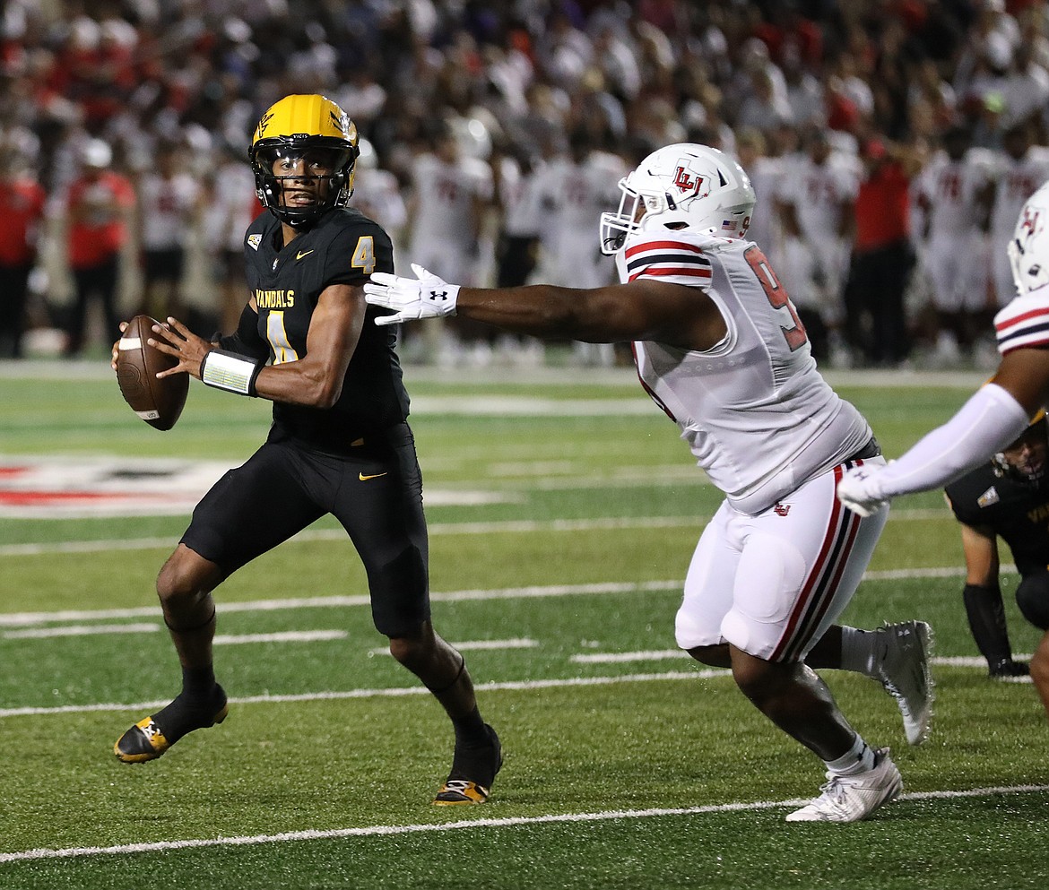 Photo by Idaho media relations
Idaho quarterback Gevani McCoy rolls out against Lamar on Thursday night in Beaumont, Texas.